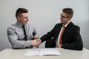 Two people talking in a job interview shaking hands